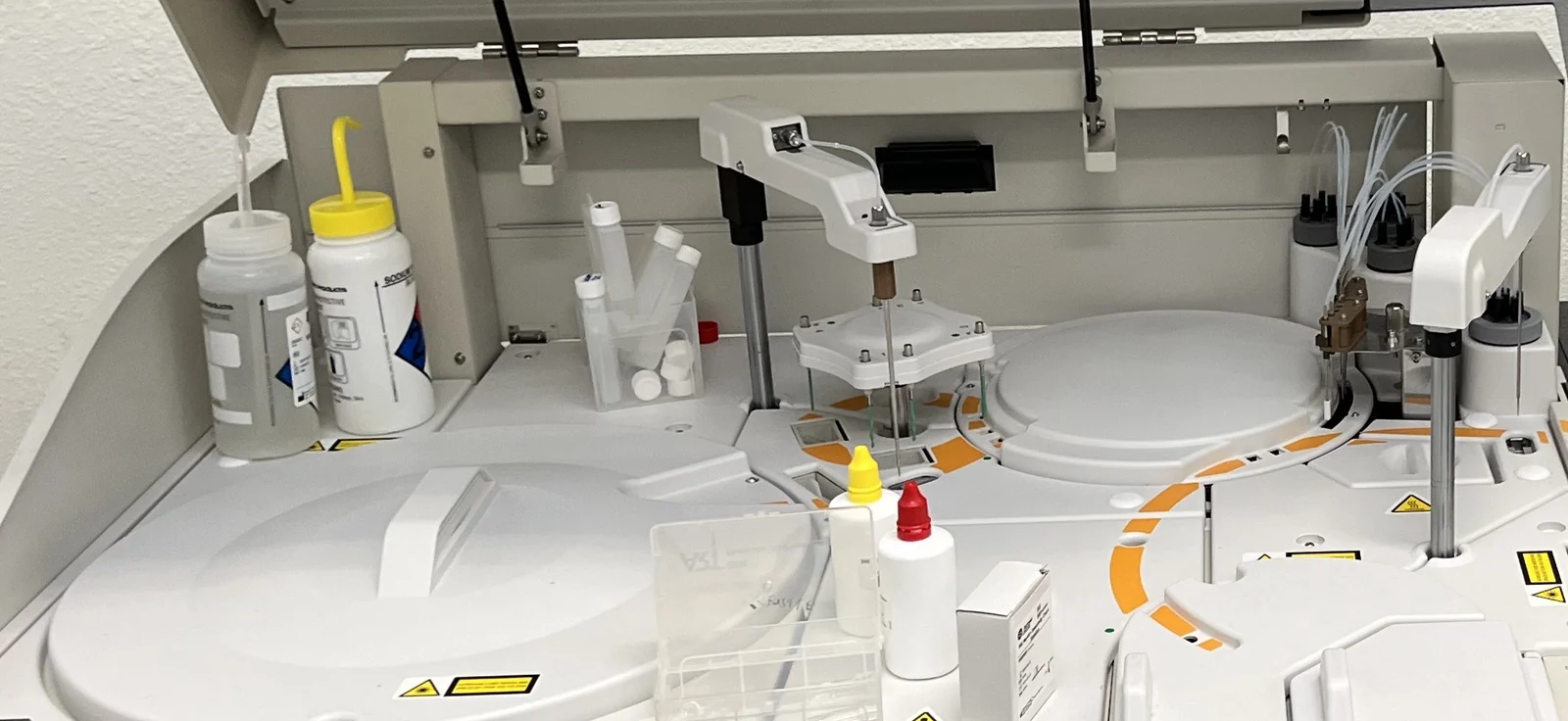 An open laboratory analyzer in Qvin Labs, Menlo Park, with its sample arms over the reaction carousel