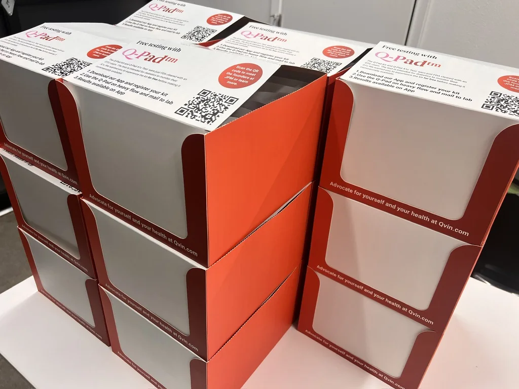 Q-Pads in branded display boxes, ready to be picked up at a physician office